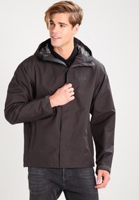 Men's waterproof jacket in dark gray, with a hood, zip closure, gray inner lining, and logo on the chest. Features adjustable cuffs.