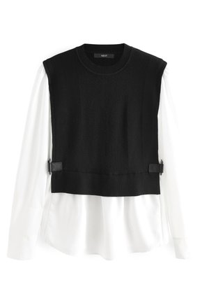 Gilet noir sans manches en tricot superposé sur un chemisier blanc à manches longues avec fronces à l'ourlet et boucles latérales réglables.