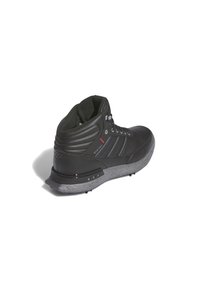 High-top black waterproof shoe with textured leather upper, gray speckled sole, and red accents on the side; features lace-up closure.