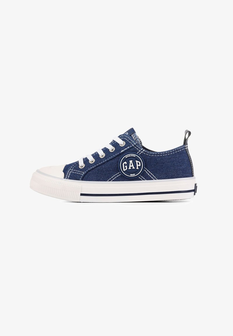 Blue denim sneaker with white rubber toe cap and outsole. Features logo patch, white laces, and contrasting stitching details.
