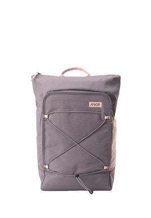 Gray rectangular backpack with front zip pocket, elastic crosscord, side mesh pocket, and pink handle on top.