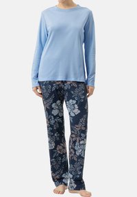 Vaaleansininen pitkähihainen paita yhdistettynä tummansinisiin kukkakuosisiiin housuihin, joissa on vaaleanpunaisia ja valkoisia kukkia. Materiaali on pehmeä ja mukava.