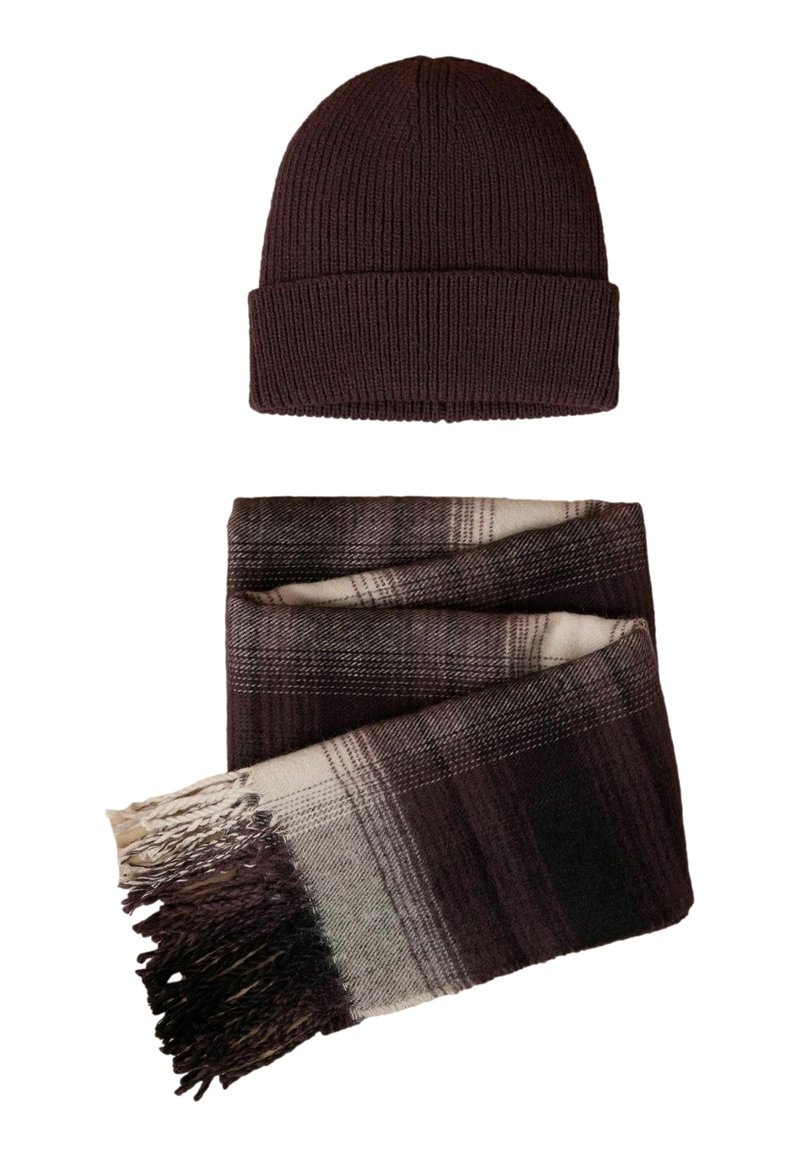 Dark purple knit beanie above a plaid scarf in shades of dark purple, cream, and gray, featuring fringe details at the ends.