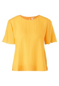 Blusa gialla a maniche corte con scollatura rotonda e orlo ondulato. Realizzata in tessuto testurizzato con una chiusura discreta sul retro.