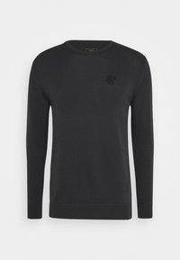 Svart stickad tröja med rund halsringning, långa ärmar, ribbad nederkant och muddar, samt en broderad logotyp på bröstet.