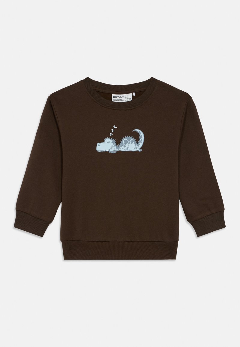 Temno rjava dolgo rokavi otroška majica s svetlo modrim risanim dinozavrom, ki spi, in "zzz" nad njegovo glavo na prsih.