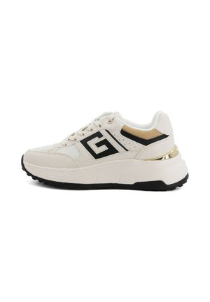 Beige athletic shoes with a textured upper, black accents, gold detailing at the heel, and a chunky black sole. Features a logo on the side.