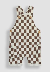 Peto a cuadros marrón y crema con tirantes ajustables, detalles de botones de madera y bolsillos laterales. Tela de algodón con dobladillos enrollados.