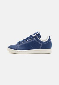 Navy blue leather sneakers with white accents, round toe, lace closure, and perforated detailing on the sides. Logo on tongue and heel.