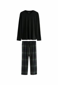 Top negro de manga larga combinado con pantalones de estampado de cuadros en verde oscuro y gris, con una cinturilla elástica y un corte holgado.