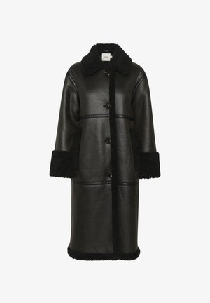 Black leather coat featuring a shearling collar and cuffs, with two front pockets and visible button closure, offering a textured finish.