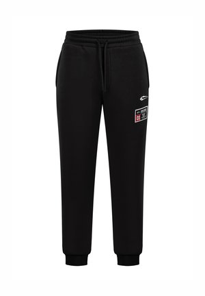 Zwarte sweatpants met een trekkoord in de taille, ribgebreide boorden en zijzakken. Het heeft een witte bedrukte logo en een genaaid label op de dij.