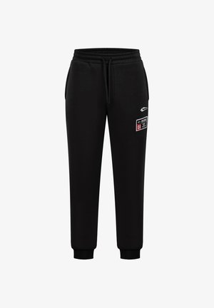 Schwarze Sweatpants mit einem Kordelzugbund, gerippten Manschetten und seitlichen Taschen. Mit einem weißen Aufdruck-Logo und einem angenähten Patch am Oberschenkel.