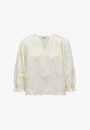 Blouse crème avec motifs texturés de palmiers, manches trois-quarts bouffantes, encolure en V et poignets élastiqués à volants.