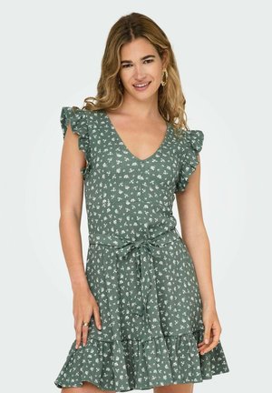 Green dress with a ruffled sleeve, V-neck, floral pattern, and a tied waist. Features a flared hem with a tiered design. Lightweight fabric.