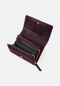 Burgundy leather wallet with gold hardware features multiple card slots and two zippered compartments, showcasing a smooth texture and clean design.