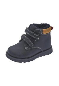 Botas de tobillo de cuero negro con dos correas de Velcro, costuras blancas, forro negro suave y un acento de gamuza marrón en el collar. Suela de goma.