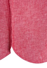 Red linen fabric with a textured finish, featuring a curved hem and a clean stitch along the edges.