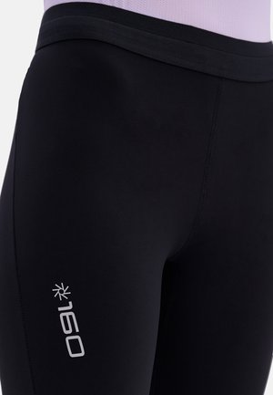 Black athletic leggings made from stretchy material, featuring a smooth texture and a subtle silver logo on the side.