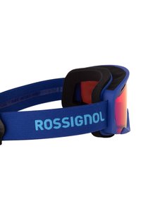 Blauwe skibril met een flexibele rand, gemirrode oranje lenzen en een zachte zwarte schuimvoering. Bevat een blauwe verstelbare band met het "ROSSIGNOL" logo.