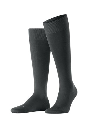 Calze grigio scuro al ginocchio realizzate in tessuto a costine. Presentano un bordo elasticizzato e una texture liscia con punta e tallone rinforzati.