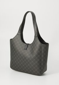 Dark gray tote bag in textured material features a circular pattern, flat handles, and a wide opening with a central tab closure.