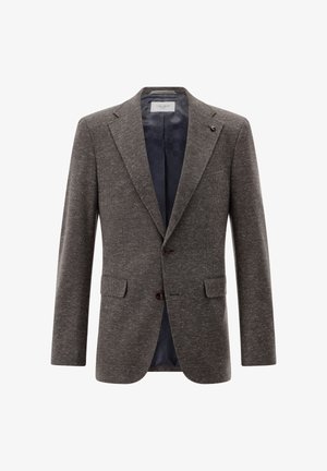Braun gemusterter Blazer mit Reverskragen, zwei Fronttaschen und zwei Knöpfen. Innenfutter aus marineblauem Stoff mit dezentem Logo-Muster.