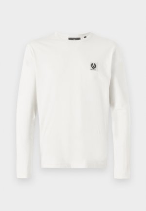 Long-sleeve white cotton t-shirt featuring a small black logo patch on the left chest and a round neckline. Smooth texture and classic fit.