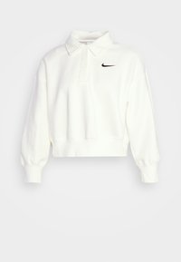Sudadera blanca recortada con cuello, mangas largas y puños elásticos. Presenta un pequeño logo negro de Nike en el pecho izquierdo. Textura suave.