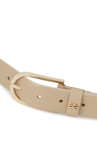 Beige leather belt featuring a circular gold-tone buckle and embossed logo detail. Adjustable with multiple holes for fit. Smooth texture.