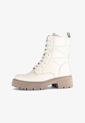 White leather ankle boots with a rounded toe, lace-up front, and moderate beige platform sole with textured grip pattern.