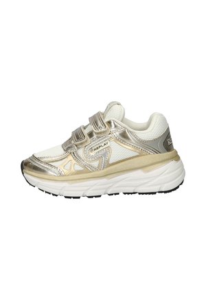 Sport shoes with white mesh upper, gold accents, and Velcro straps. Thick white sole with black tread pattern. Textured design details.