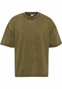 Olive green oversized t-shirt made of soft fabric, featuring a round neckline, short sleeves, and a simple embroidered logo on the chest.