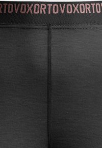 Black leggings with a textured fabric, featuring a wide black waistband. The waistband has a contrasting light pink logo pattern.