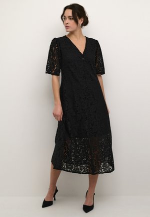 Black lace dress with short puff sleeves, V-neck, and button detail. A-line silhouette, semi-sheer texture with floral patterns.