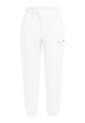 Hvide bomulds-joggingbukser med elastisk talje, sidelommer og et lille lilla logo nær hoften. Taperet benudformning.