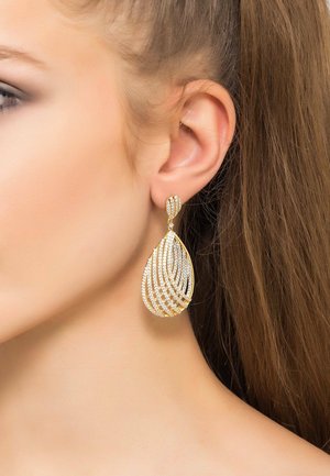 Gold-tone drop earrings featuring a spiraled design, adorned with clear rhinestones, mimicking teardrop shape, suspended from a small stud.