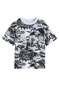 Svart och vit t-shirt med en mängd olika Batman-seriebilder och logotyper. Korta ärmar, rund halsringning, tillverkad av bomull.