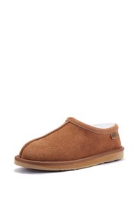 Brown suede slipper with a soft interior, rounded toe, stitched seams, and a rubber sole. Features a small logo tag on the side.
