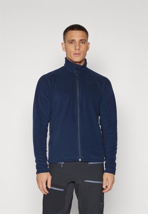 Navy blue fleece jacket with a high collar, full front zipper, and two side zip pockets; soft texture with a close-fitting design.