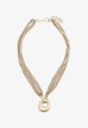 Naszyjnik z wieloma rzędami złocistych koralików z ozdobą w postaci nierównych, przeplatających się kół oraz regulowanym zapięciem na łańcuszku.