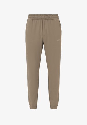 Pantalones jogger beige de tela suave, con cintura elástica, piernas ajustadas y sutiles bolsillos laterales.