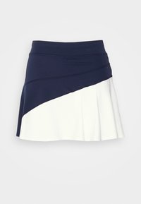 En sportkjol med en figurnära midja i marinblått och en vit plisserad nederkant, med ett diagonalt färgblockdesign. Tillverkad av stretchigt material.