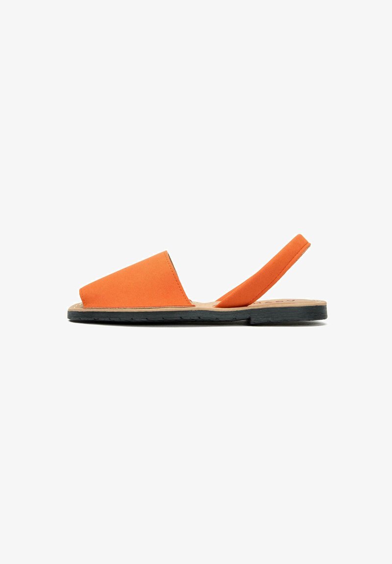 Orange suede slip-on sandal with a black rubber sole, featuring a minimalist design and a slender back strap for secure fit.