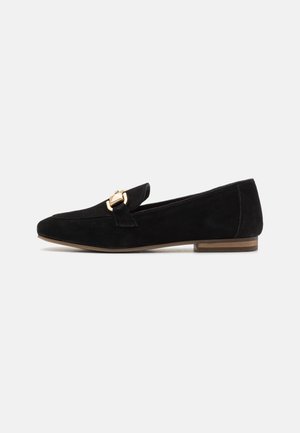 Black suede loafers with a pointed toe and a gold buckle accent. Low stacked heel and smooth texture on a minimal design.