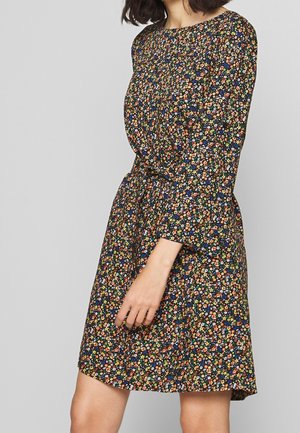 Bloemenjurk gemaakt van lichtgewicht stof, met een marineblauwe achtergrond en kleine bloemen in verschillende kleuren, lange mouwen en een losse pasvorm.