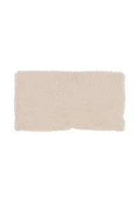 Fluffy rectangular rug in soft pink, featuring long pile texture. Edges are slightly irregular, enhancing its cozy appearance.