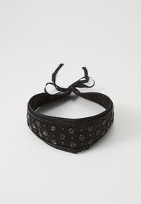 Svart stoff choker med intrikate perler og dekorasjoner, med en jevn tekstur og satengbånd for feste.
