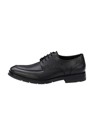 Schwarzer, strukturiert geprägter Herrenschuh aus Leder mit Schnürung vorne und dicker Gummisohle, von der Seite auf weißem Hintergrund gezeigt.
