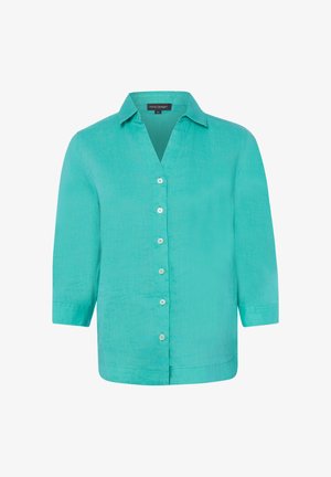 Blouse en lin turquoise avec un col classique, sept boutons blancs sur le devant et des manches trois-quarts.